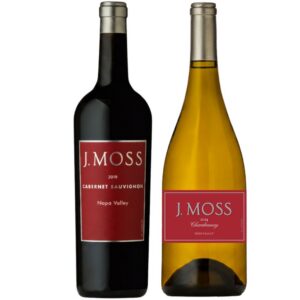 Two J. Moss wine bottles: a dark Cabernet Sauvignon on the left and a golden Chardonnay on the right, Napa Valley labels visible.